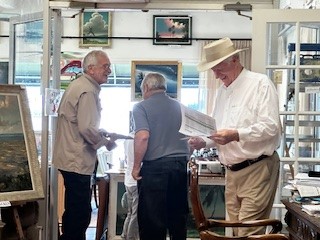 People At Auction Looking At Paintings